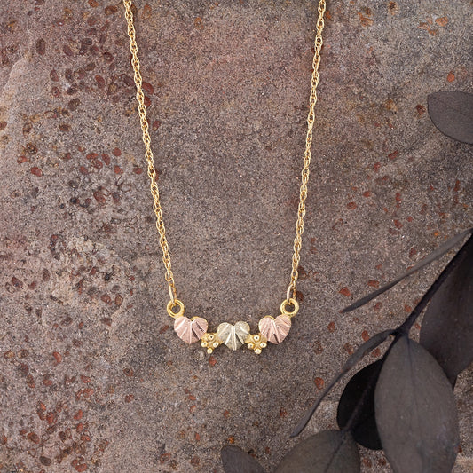 10K yellow gold heart leaf bar necklace by Landstrom's Black Hills Gold, styled view