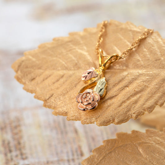 10K yellow gold curved rose stem pendant by Landstrom's Black Hills Gold, styled view