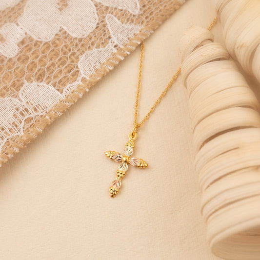 10K yellow gold alternating leaf and grape cluster cross pendant by Landstrom's Black Hills Gold, styled view
