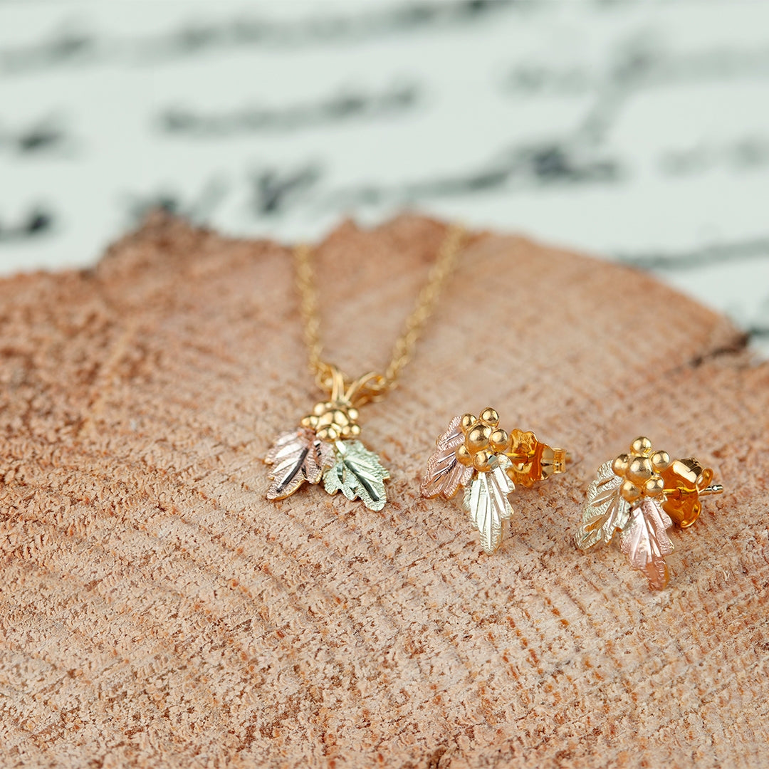 10K yellow gold grape cluster and double leaf pendant by Landstrom's Black Hills Gold, styled view