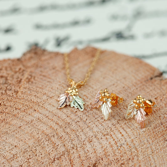 10K yellow gold grape cluster and double leaf pendant by Landstrom's Black Hills Gold, styled view