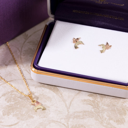 Hummingbird pendant in 12K pink and green gold by Landstrom's Black Hills Gold, styled view