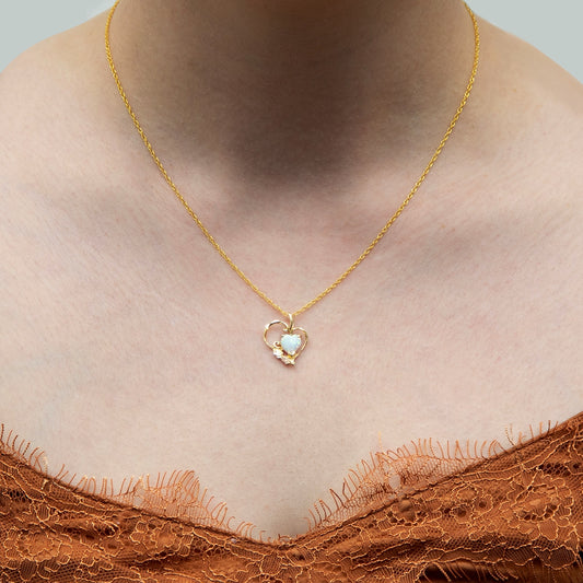 10K yellow gold created heart opal double leaf heart pendant by Landstrom's Black Hills Gold, shown worn