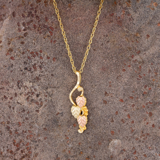 10K yellow gold leaf hanging grapevine pendant by Landstrom's Black Hills Gold, styled view