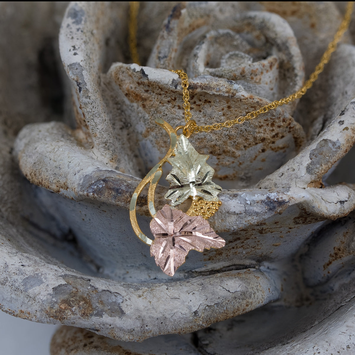 10K yellow gold leaf and grape cluster pendant by Landstrom's Black Hills Gold, styled view