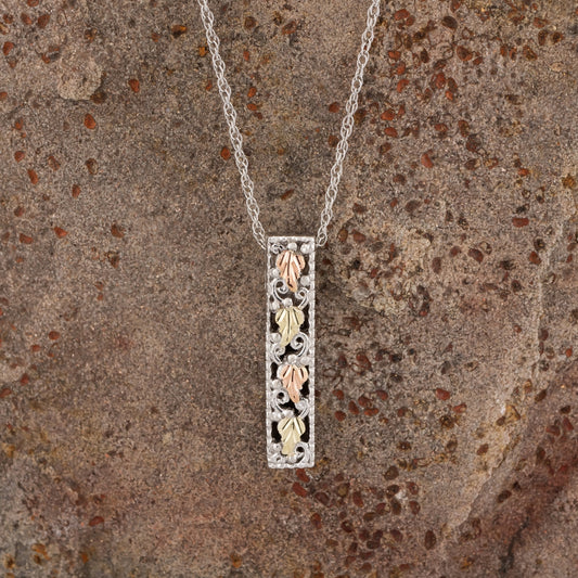 Sterling silver leaf vertical bar pendant by Mt. Rushmore Black Hills Gold, styled view