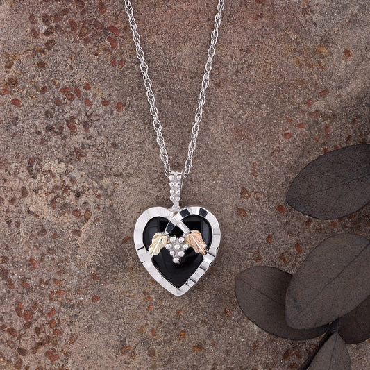 Sterling silver heart onyx and leaf pendant by Landstrom's Black Hills Gold, styled view