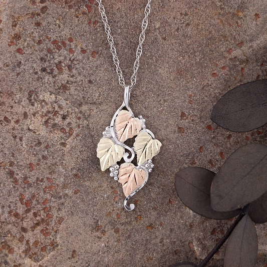 Sterling silver four leaf and grape cluster pendant by Landstrom's Black Hills Gold, styled view