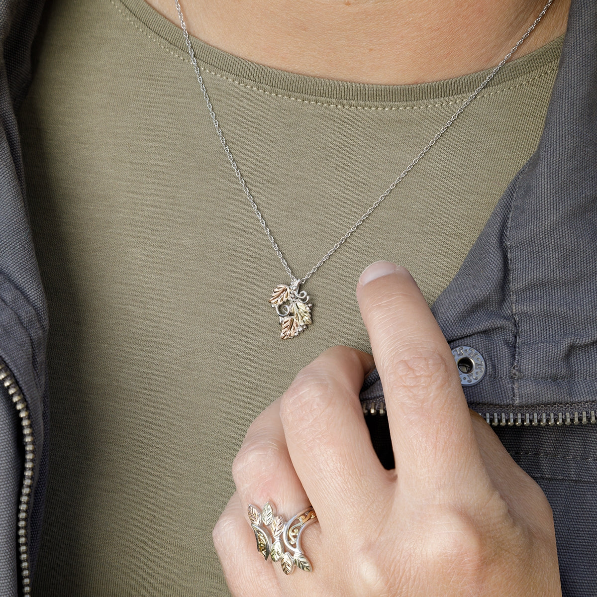 Sterling silver three leaf and grapevine pendant by Landstrom's Black Hills Gold, shown worn