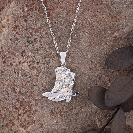 Sterling silver cowboy boots pendant by Landstrom's Black Hills Gold, styled view