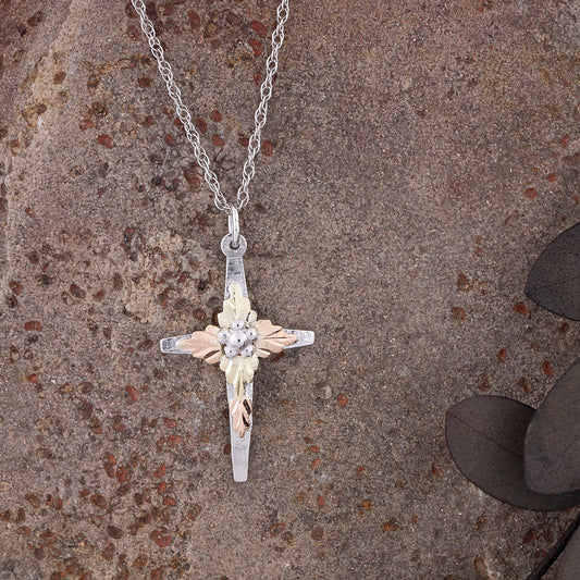 Sterling silver grape cluster center cross pendant by Landstrom's Black Hills Gold, styled view