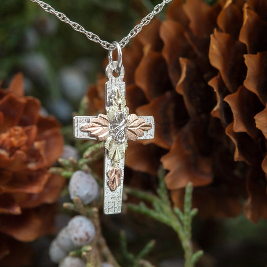 Sterling silver leaf center cross pendant by Landstrom's Black Hills Gold, styled view