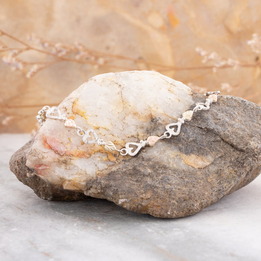 Sterling silver 7" leaf and heart link bracelet by Landstrom's Black Hills Gold, styled view