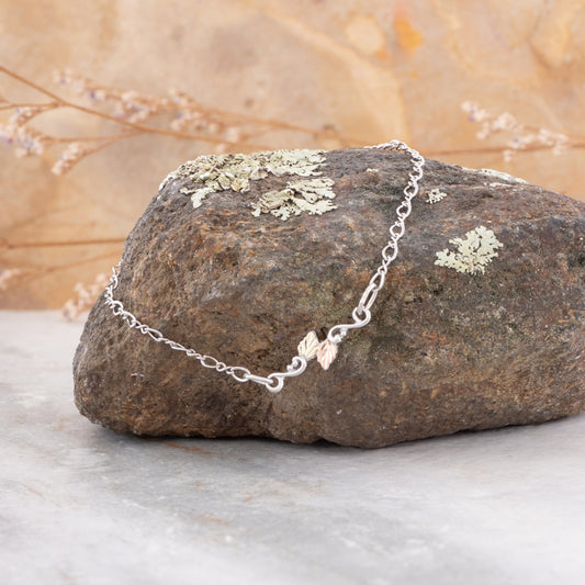 Sterling silver double leaf link bracelet by Landstrom's Black Hills Gold, styled view