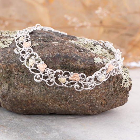 Sterling silver filigree leaf link bracelet by Landstrom's Black Hills Gold, styled view