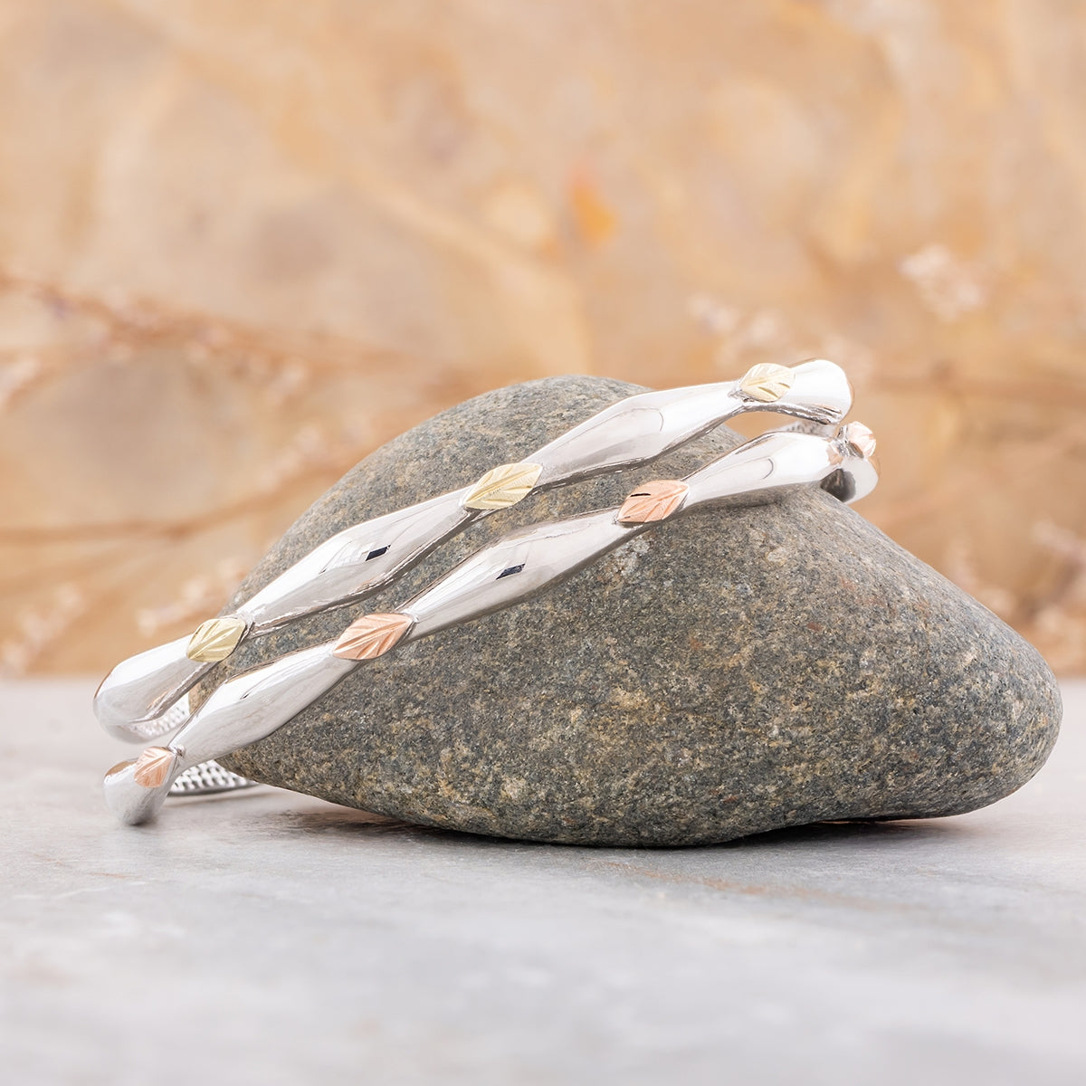 Sterling silver double vine and leaf cuff bracelet by Landstrom's Black Hills Gold, styled view
