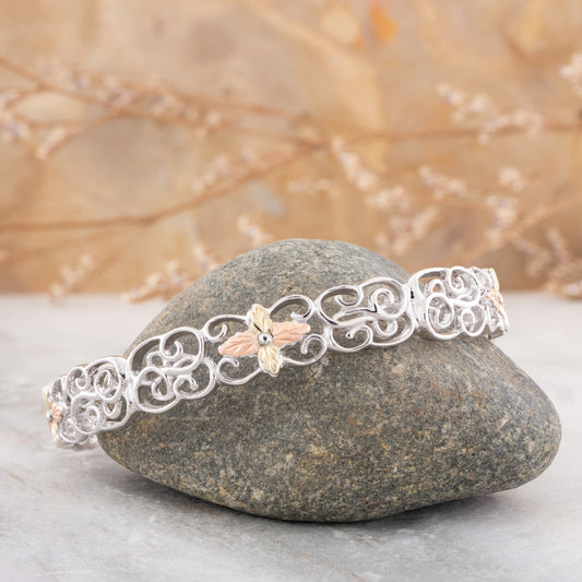 Sterling silver filigree cuff bracelet by Landstrom's Black Hills Gold, styled view
