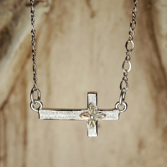 Sterling silver sideways cross necklace by Landstrom's Black Hills Gold, styled view