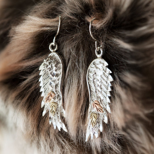 Sterling silver angel wing dangle earrings by Landstrom's Black Hills Gold, styled view
