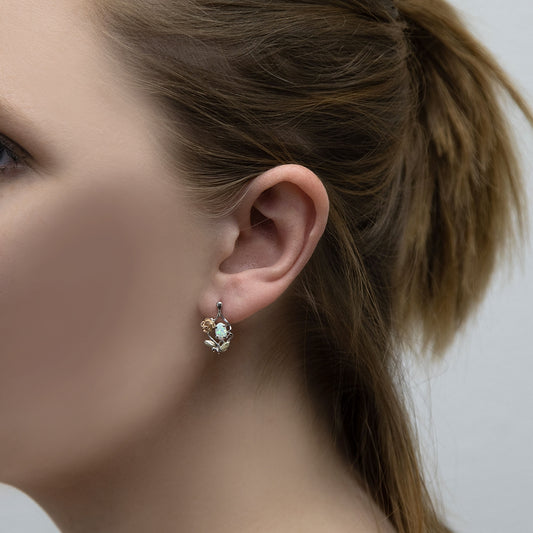 Sterling silver created oval opal and rose earrings by Landstrom's Black Hills Gold, shown worn