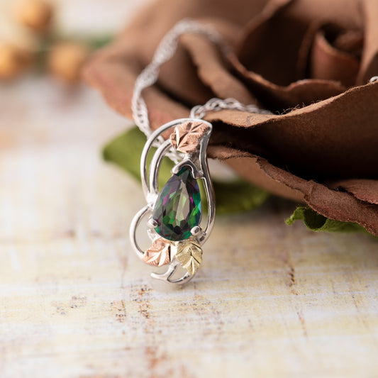 Sterling silver pear mystic fire topaz and leaf pendant by Landstrom's Black Hills Gold, styled view
