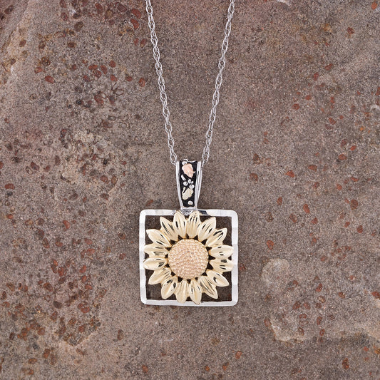 Sterling silver sunflower diamond cut square pendant by Landstrom's Black Hills Gold, styled view