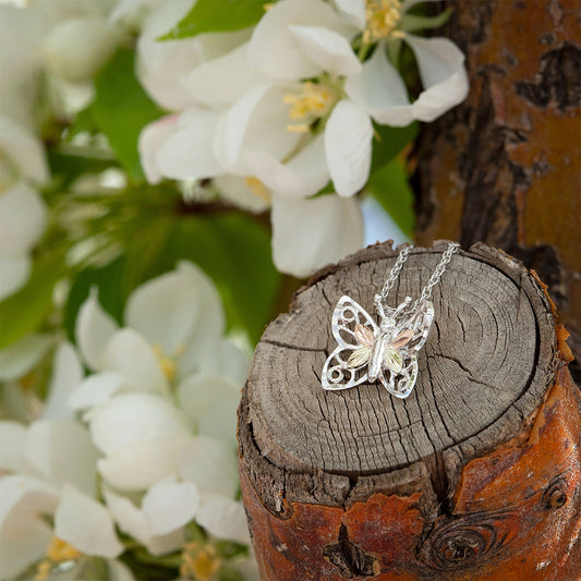 Sterling silver diamond cut four leaf butterfly pendant by Landstrom's Black Hills Gold, styled view