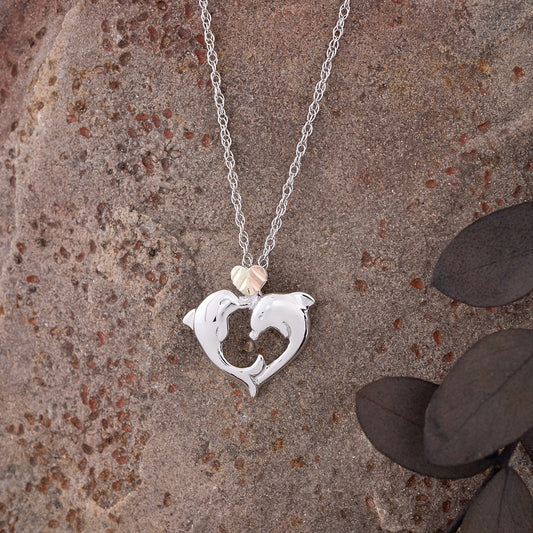 Sterling silver double dolphin heart pendant by Landstrom's Black Hills Gold, styled view