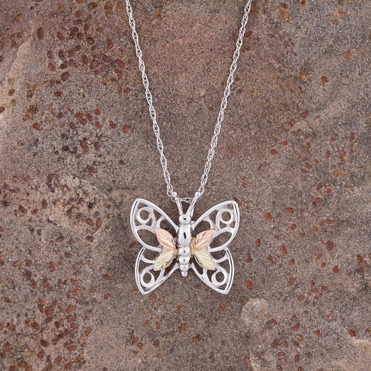 Sterling silver four leaf butterfly pendant by Landstrom's Black Hills Gold, styled view
