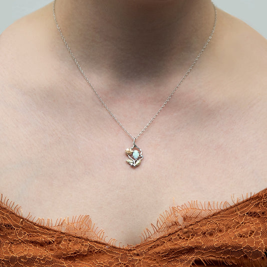 Sterling silver created oval opal and rose pendant by Landstrom's Black Hills Gold, shown worn