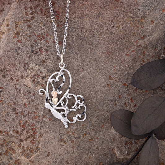 Sterling silver diamond cut winged butterfly pendant by Landstrom's Black Hills Gold, styled view