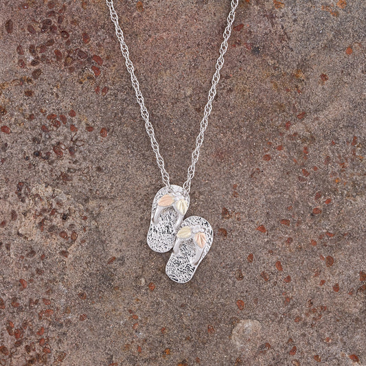 Sterling silver flip flops pendant by Landstrom's Black Hills Gold, styled view