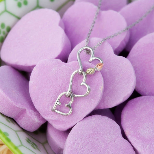 Sterling silver triple graduated heart pendant by Landstrom's Black Hills Gold, styled view