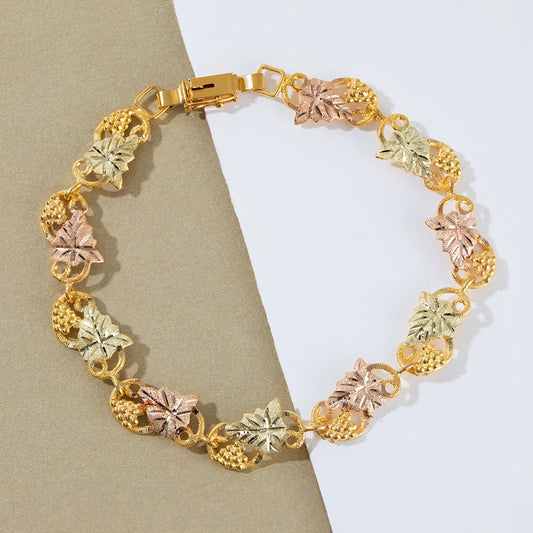10K yellow gold pink and green leaf loop vine 7.5" link bracelet by Landstrom's Black Hills Gold, styled view