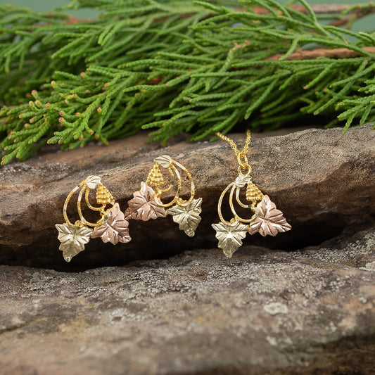 10K yellow gold curved grapevine drop earrings by Landstrom's Black Hills Gold, styled view