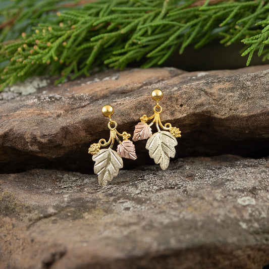 10K yellow gold double leaf grapevine dangle earrings by Landstrom's Black Hills Gold, styled view