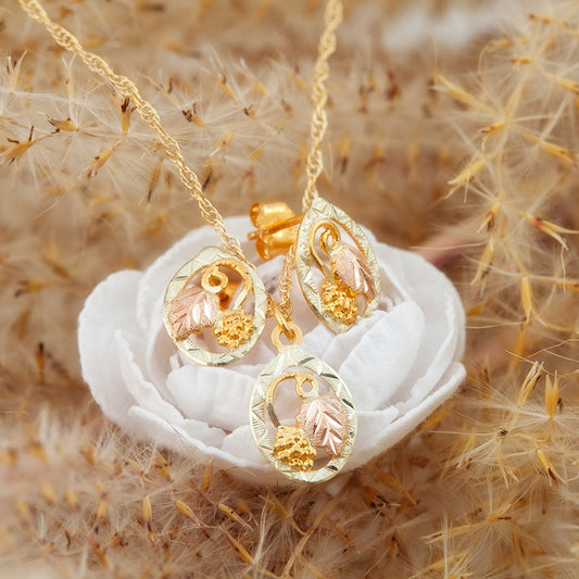 10K yellow gold open oval leaf and grape pendant by Landstrom's Black Hills Gold, styled view