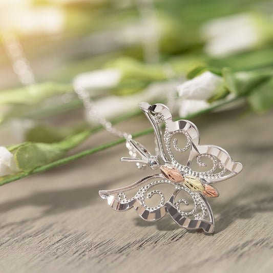 Sterling silver milgrain wing butterfly pendant by Landstrom's Black Hills Gold, styled view