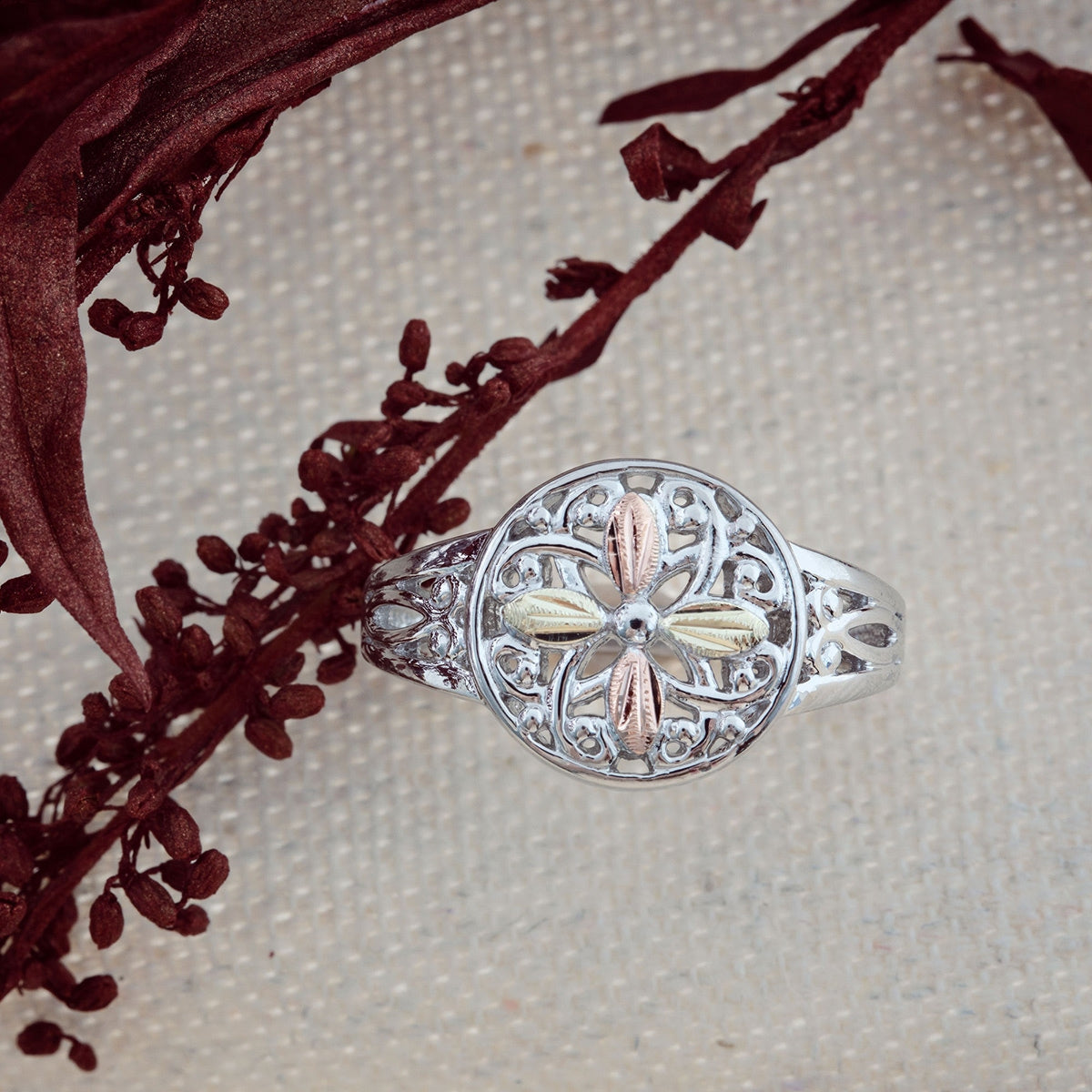 Sterling silver swirl disc ring by Landstrom's Black Hills Gold, styled view