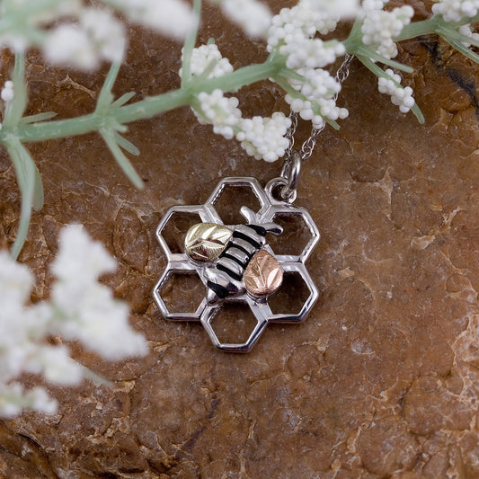 Sterling silver honeycomb bee pendant by Landstrom's Black Hills Gold, styled view