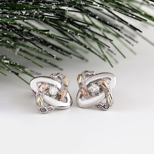 Sterling silver 1/5 ct. tw. round diamond love knot earrings by Landstrom's Black Hills Gold, styled view