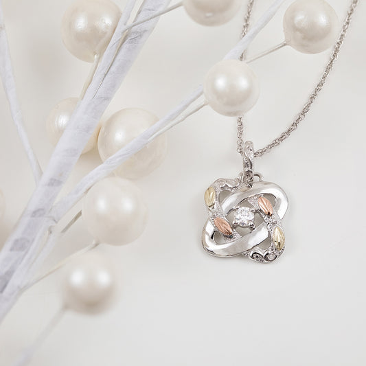Sterling silver 1/6 ct. tw. round diamond love knot pendant by Landstrom's Black Hills Gold, styled view