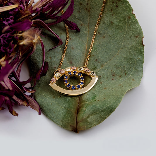 10K yellow gold created sapphire eye necklace by Landstrom's Black Hills Gold, styled view