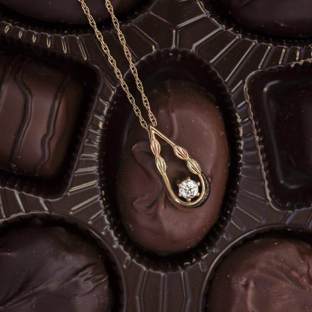 10K yellow gold noventa and Black Hills Gold 1/3 ct. tw. round diamond teardrop pendant