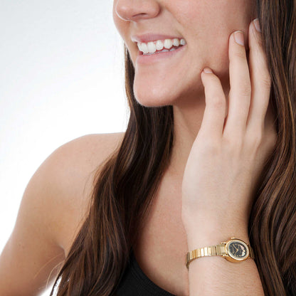 Women's quartz gold-tone stainless steel watch featuring black oval dial by Mt. Rushmore Black Hills Gold, shown worn