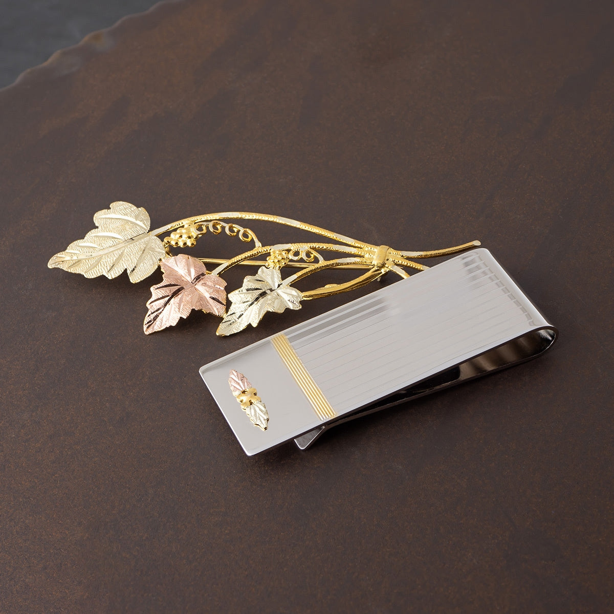 Double leaf and grape lined money clip by Landstrom's Black Hills Gold, styled view