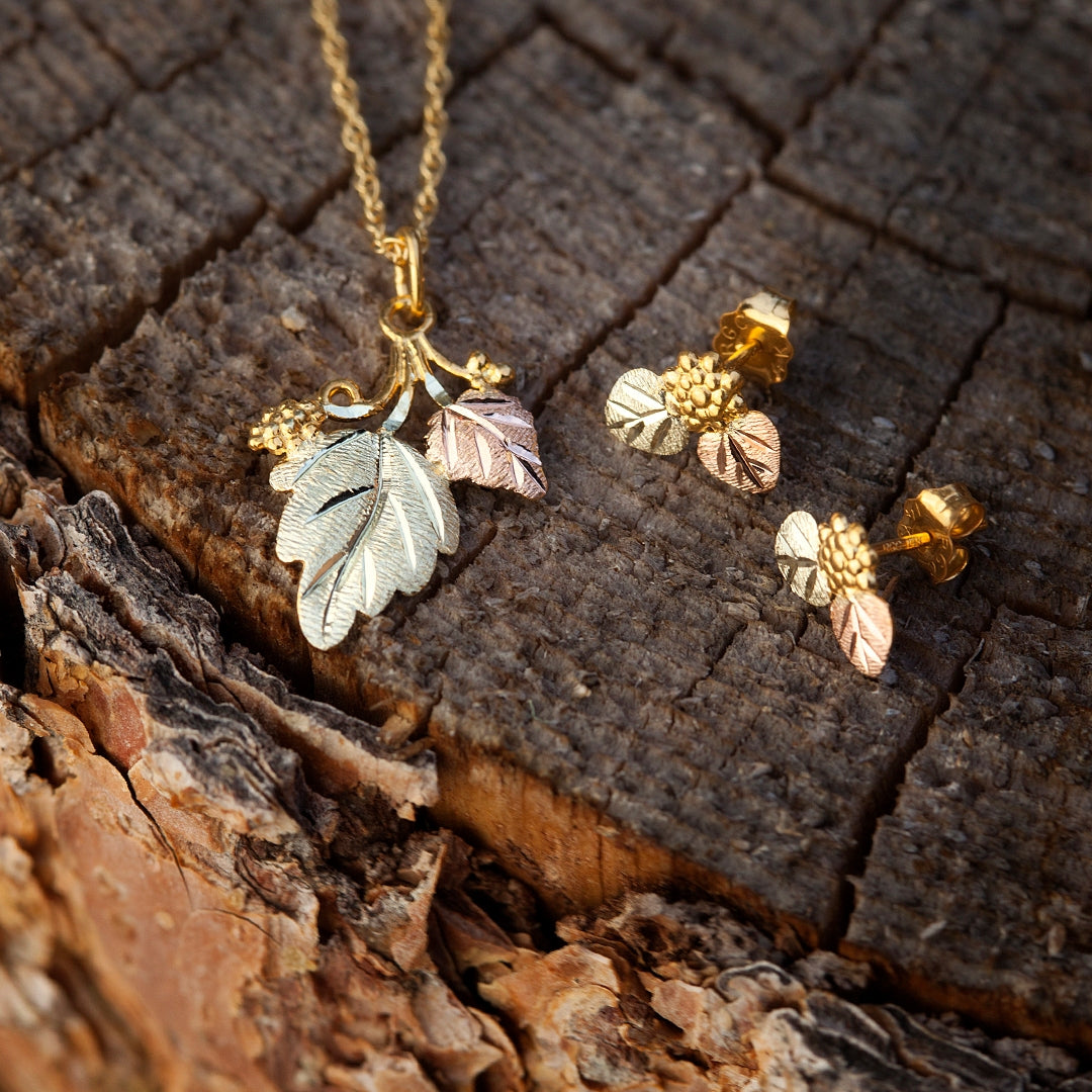 10K yellow gold hanging double leaf grapevine pendant by Landstrom's Black Hills Gold, styled view