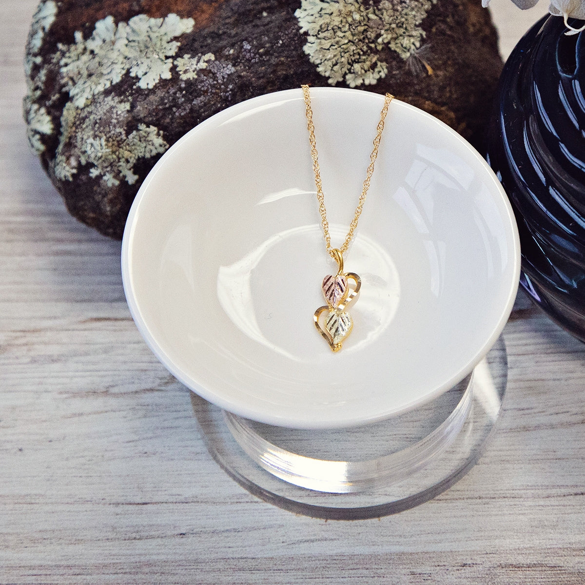 10K yellow gold double leaf half heart pendant by Landstrom's Black Hills Gold, styled view