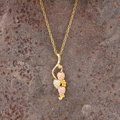 10K yellow gold leaf hanging grapevine pendant by Landstrom's Black Hills Gold, styled view