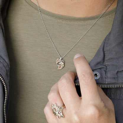 Sterling silver three leaf and grapevine pendant by Landstrom's Black Hills Gold, shown worn